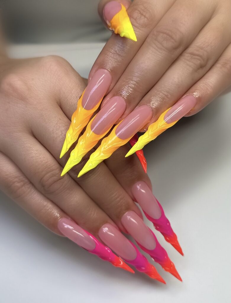 Beautiful long nails with vibrant freestyle nail designs, created at a top nail salon in Las Vegas, featuring Gel X nails and acrylic nails with intricate patterns and decorative accents.