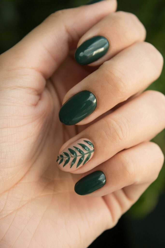 Fresh green nails with delicate leaf designs, showcasing a natural and stylish look