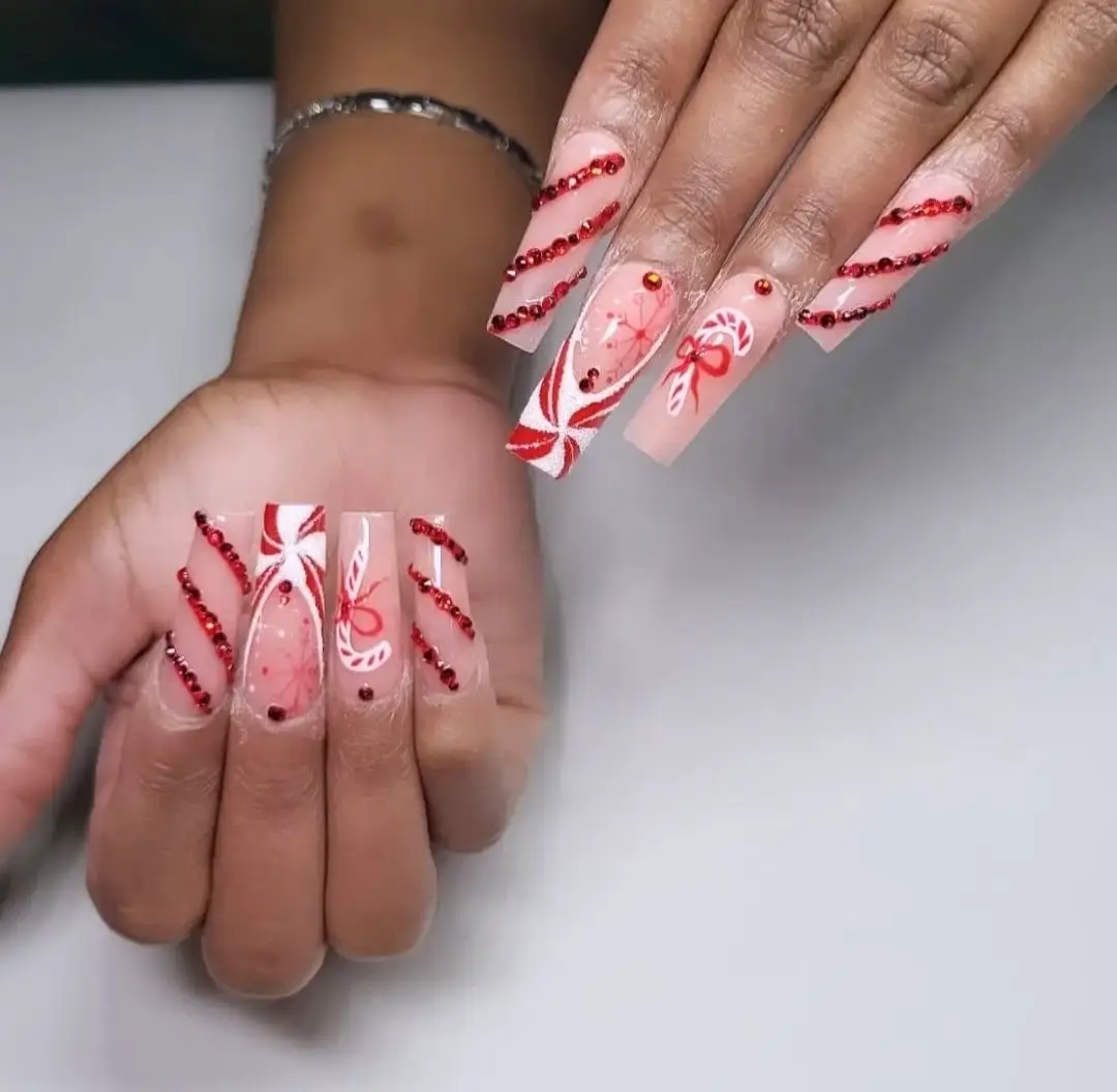 Festive candy cane nail art done by our top nail technicians red and white stripes, perfect for holiday nail art.