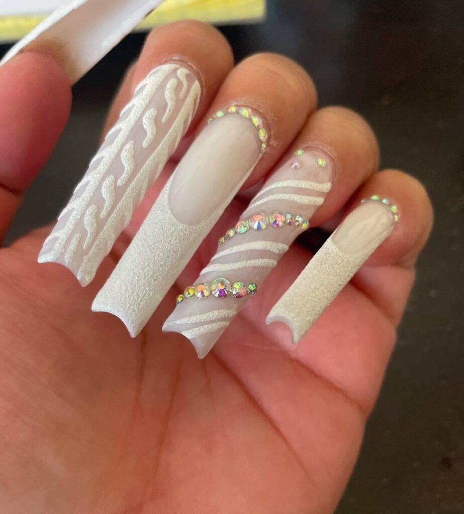 Long white sculpted 3D acrylic full set with sweater-knit texture and rhinestones at NAB Nail Bar, Las Vegas