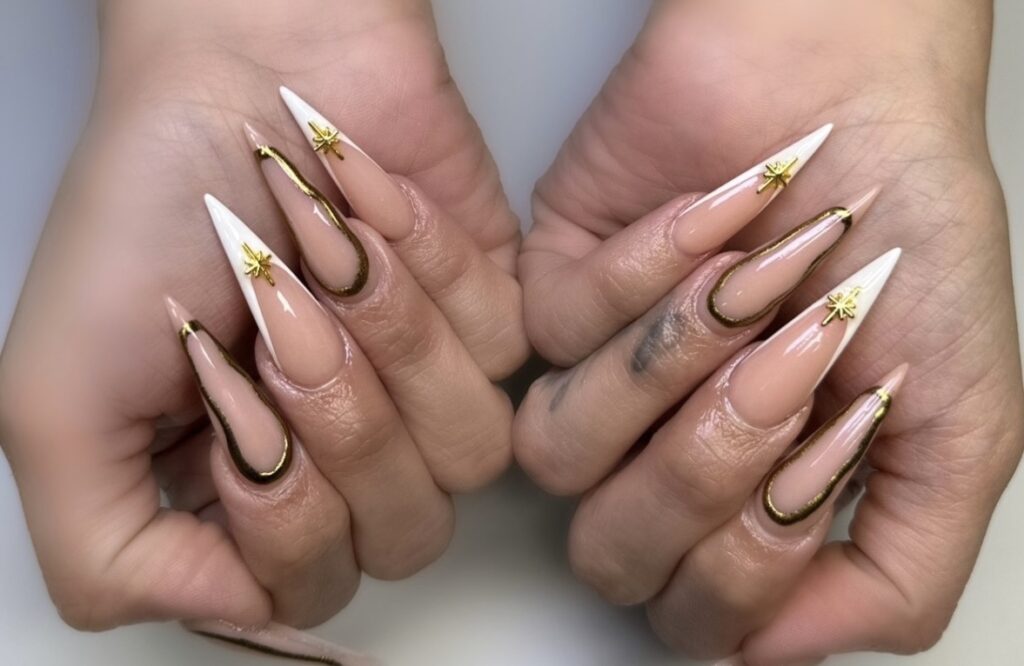 Gold and white glittery nails designed for a festive New Year's Eve look