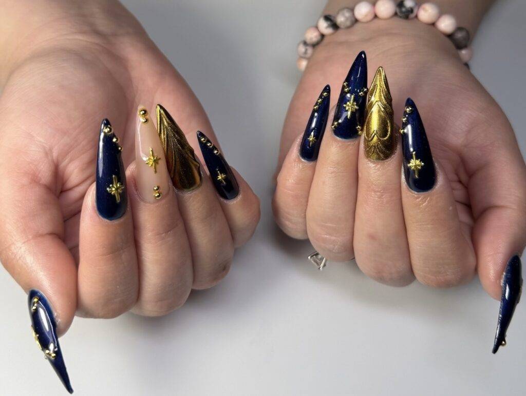 Blue and gold nail extensions with gemstones, perfect for a luxurious pedicure