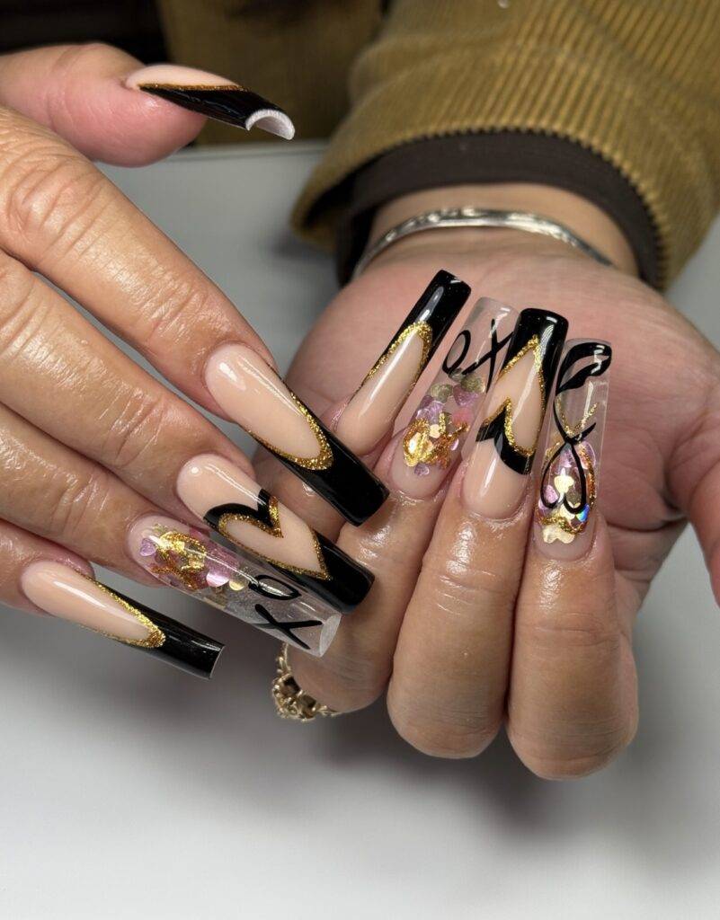 Elegant black and gold Valentine's Day nail art with encapsulation, designed for a luxurious look in Las Vegas