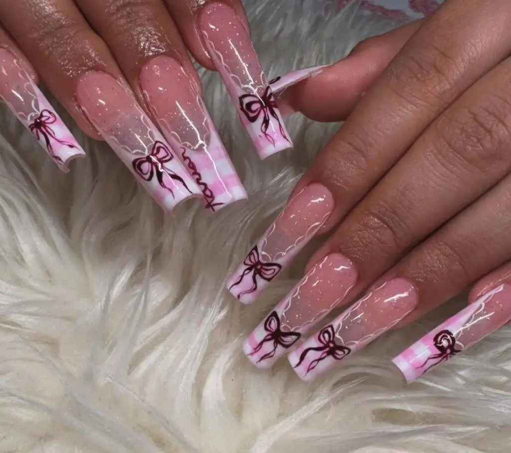 Pink Plaid Bow Valentines Day Nail Art in Las Vegas Nab Nail Bar | Nails Lashes and Beauty in Las Vegas Charming valentines day nails featuring a pink plaid design with bows perfect for a playful and romantic look in las vegas Nab nail bar | nails lashes and beauty in las vegas