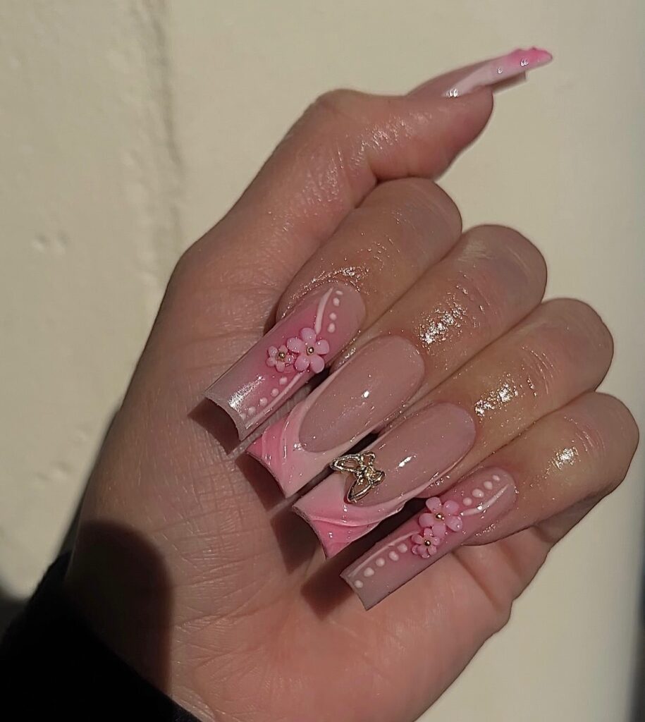 Luxury high-end nail art by Dayse featuring intricate 3D floral designs on long acrylic nails.