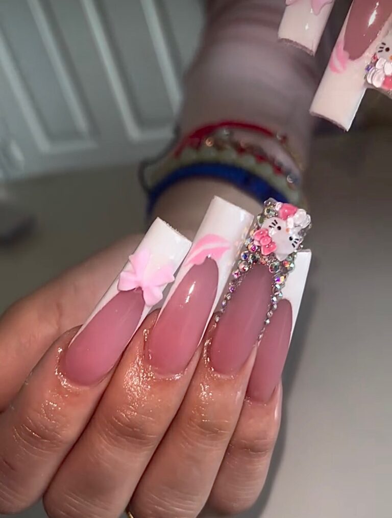 Deep French long nails featuring Hello Kitty nail art and sparkling rhinestone accents for a glamorous and playful look.