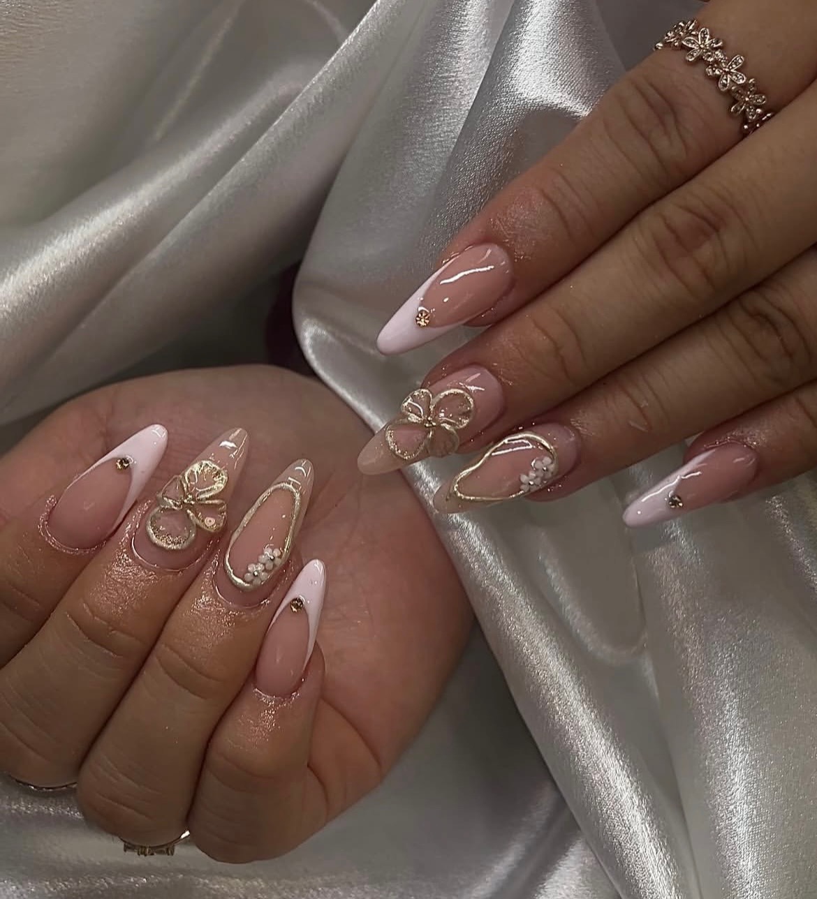 Gel X nails with deep French tips and intricate nail art, combining elegance and creativity for a stylish, polished look.