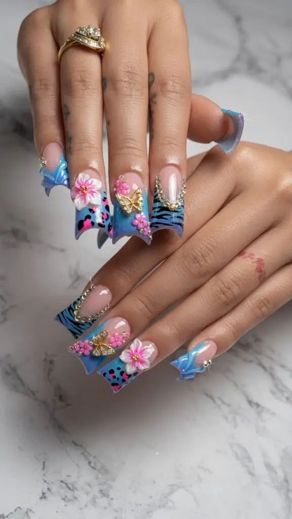 Blue and pink freestyle duck nails design with 3d flowers and butterflies at nab nail bar in las vegas nab nail bar | nails lashes and beauty in las vegas
