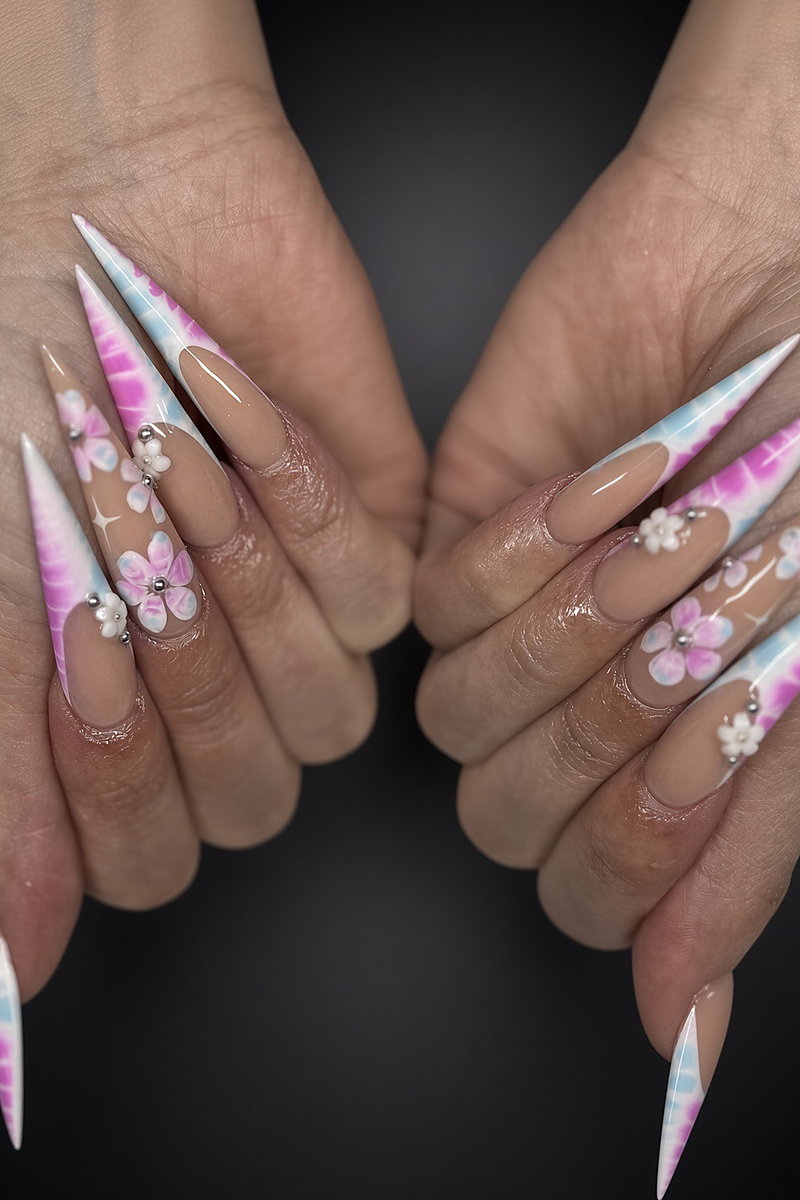 Long stiletto acrylic nails with pastel pink tie-dye tips and white 3D flowers, done at NAB Nail Bar in Las Vegas