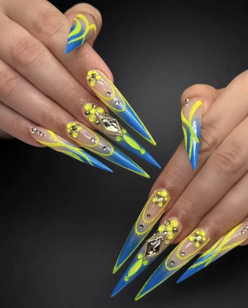 Long stiletto Gel X nails in neon yellow and blue with rhinestones and 3D flowers at NAB Nail Bar in Las Vegas
