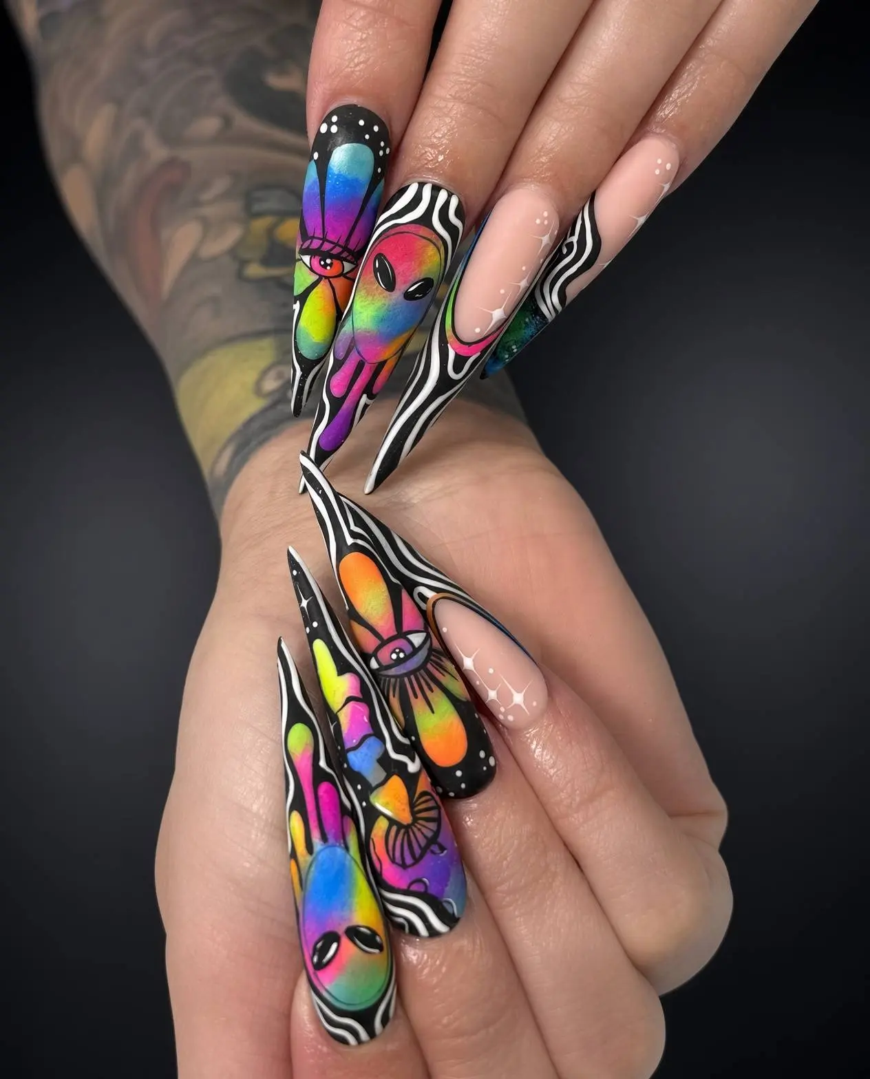 Hand painted psychedelic alien nail art on ultra-long stiletto nails in rainbow colours, done at NAB Nail Bar in Las Vegas