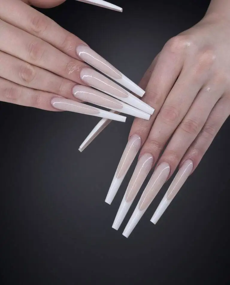 Close up of long coffin shaped gel x nails with a nude base and a white milky french tip done at nab nail bar in las vegas nab nail bar