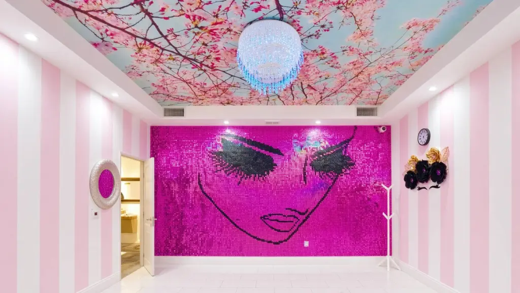 Nablashroomdesktop Nab Nail Bar | Nails Lashes and Beauty in Las Vegas Boutique interior with pink striped walls a magenta mosaic wall forming a womans face and a crystal chandelier under a cherry blossom ceiling Nab nail bar | nails lashes and beauty in las vegas
