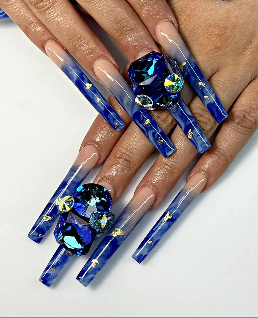2.5 inch custom square straight-tip Gel X nails with blue marble, gold foil and oversized sapphire crystals, custom made with NABulous tips at NAB Nail Bar in Las Vegas