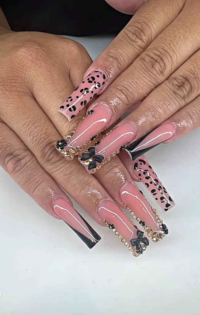 Extra long square Gel X nails in nude with black bows, gold crystals and leopard print at NAB Nail Bar in Las Vegas