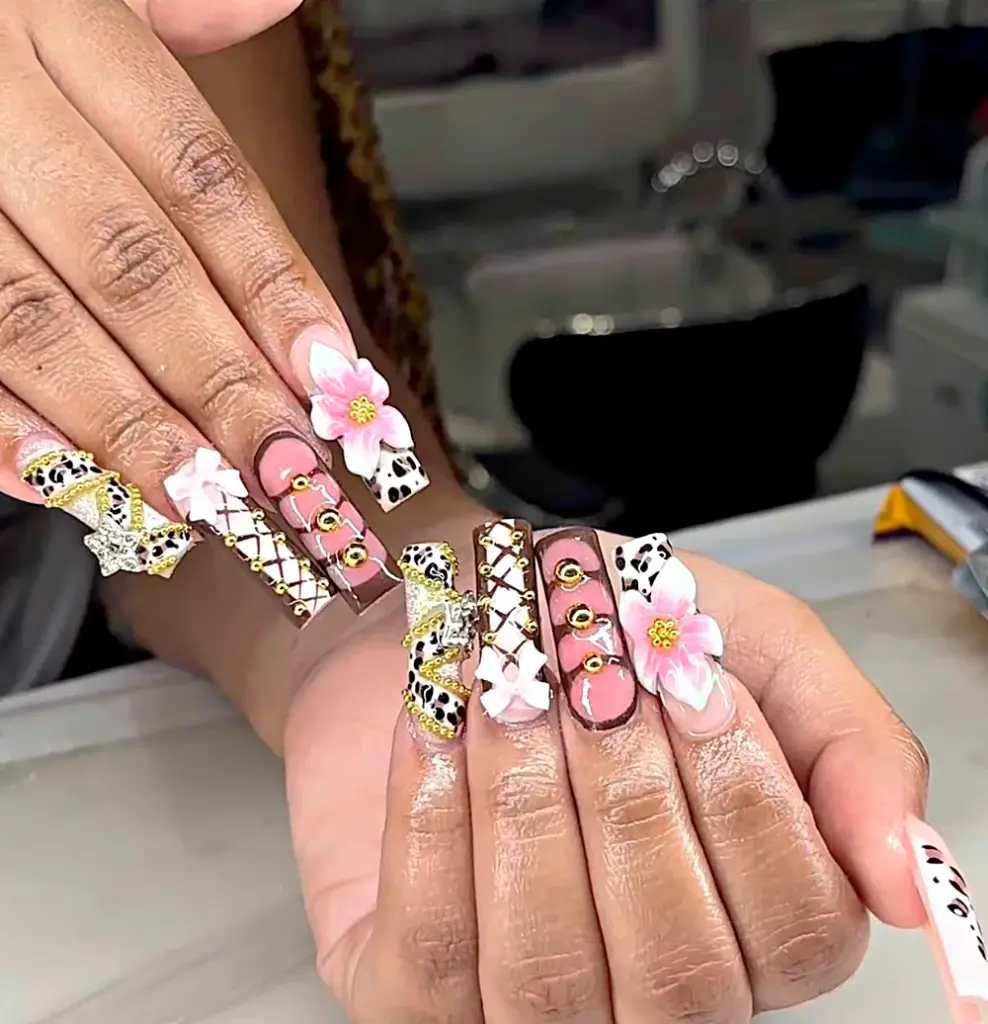 Extra long square Gel X nails in pink and brown with leopard print, gold beads and a 3D flower at NAB Nail Bar in Las Vegas