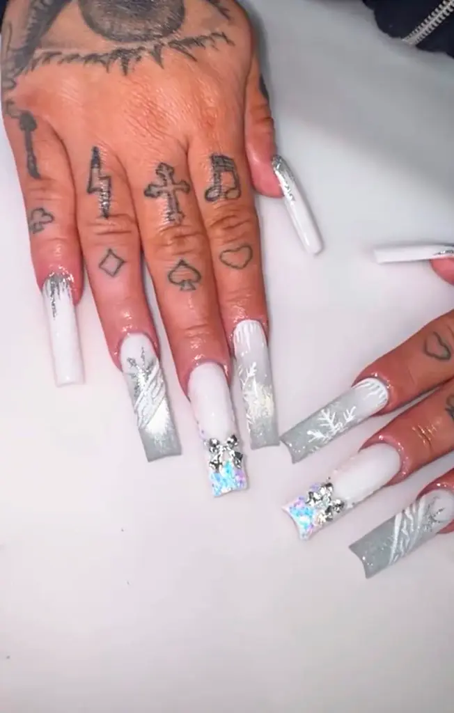 Extra long square Gel X nails in white and silver with snowflakes and a crystal bow at NAB Nail Bar in Las Vegas