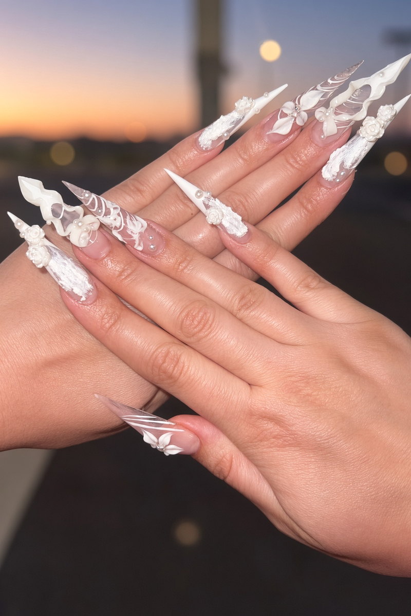 Wedding Nails Las Vegas Extralong White 3d Stiletto Set at Sunset Nab Nail Bar Extra long white stiletto wedding nails with sculpted 3d flowers and bows photographed against a las vegas sunset nab nail bar