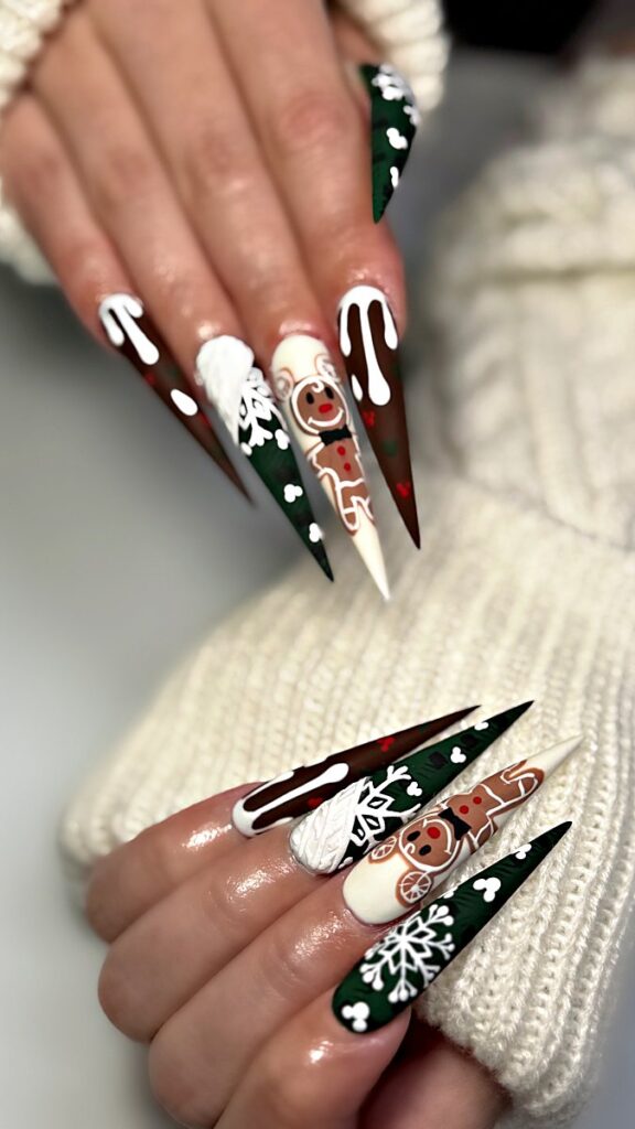Gingerbread man Christmas stiletto nails with 3D sweater knit, snowflakes and icing drips at NAB Nail Bar, Las Vegas
