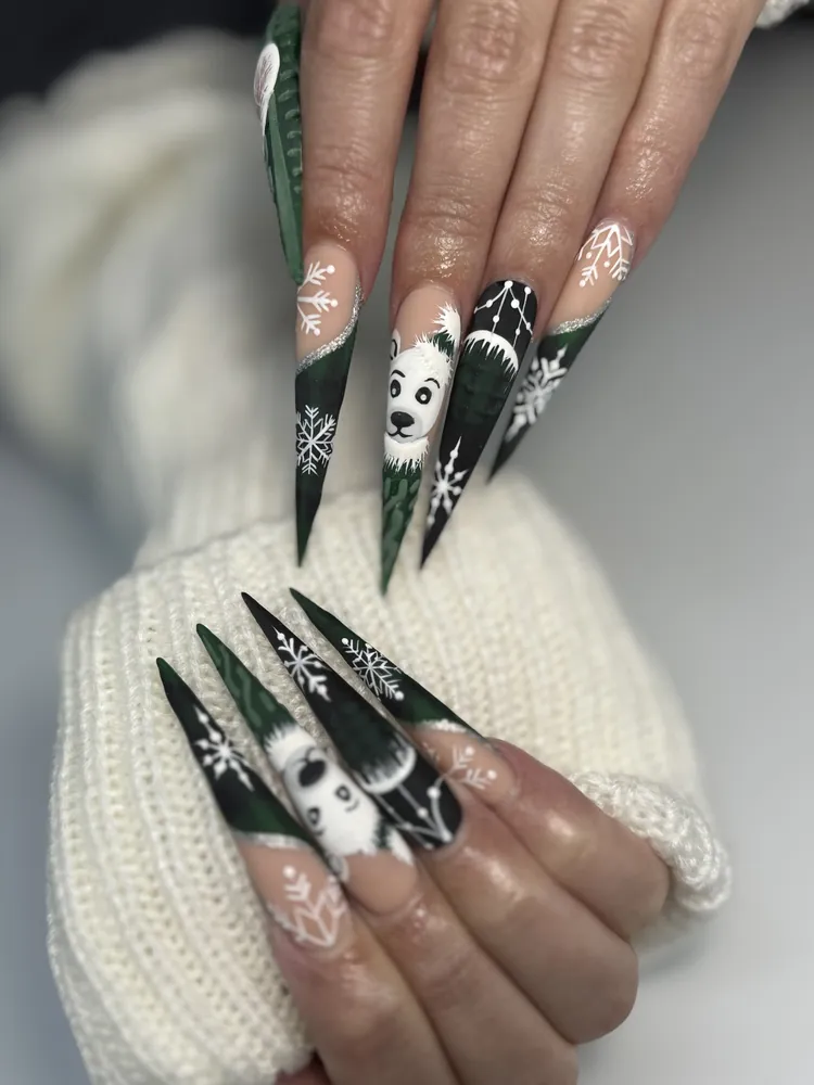 Long dark green and black stiletto nails with a hand-painted polar bear, snowflakes and silver glitter at NAB Nail Bar Las Vegas