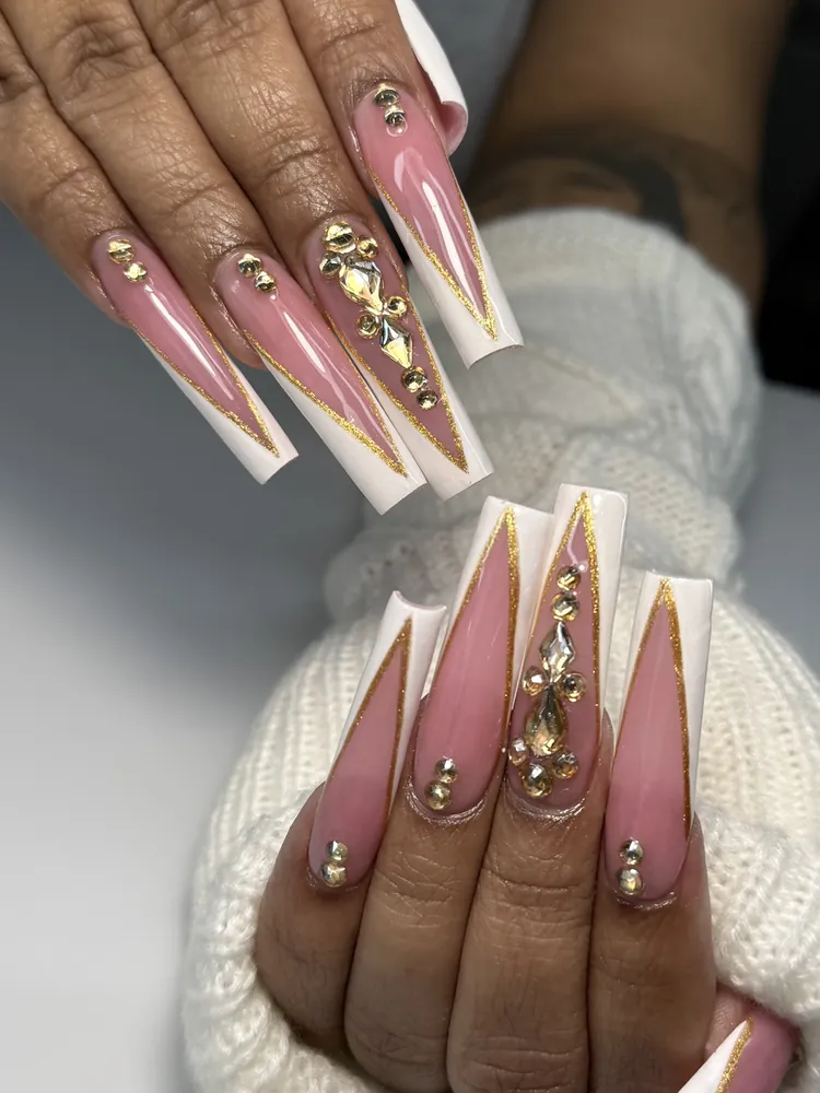 Long pink nails with white French edges, gold glitter lines and gold gems for a holiday event at NAB Nail Bar Las Vegas