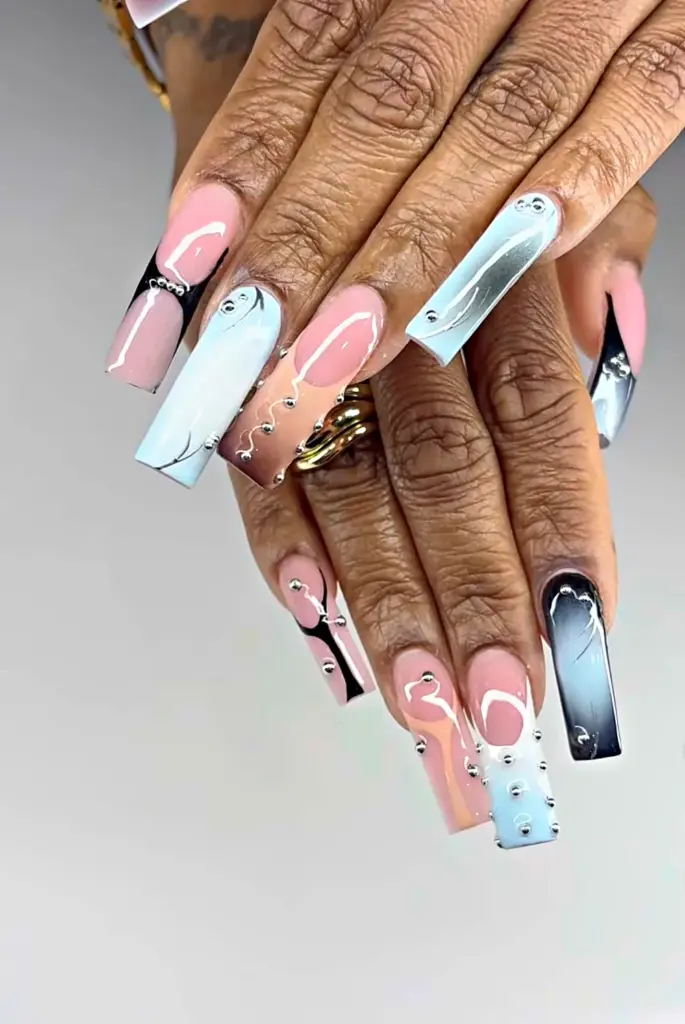 Long square Gel X nails with blue and black ombré, nude and silver studs at NAB Nail Bar in Las Vegas
