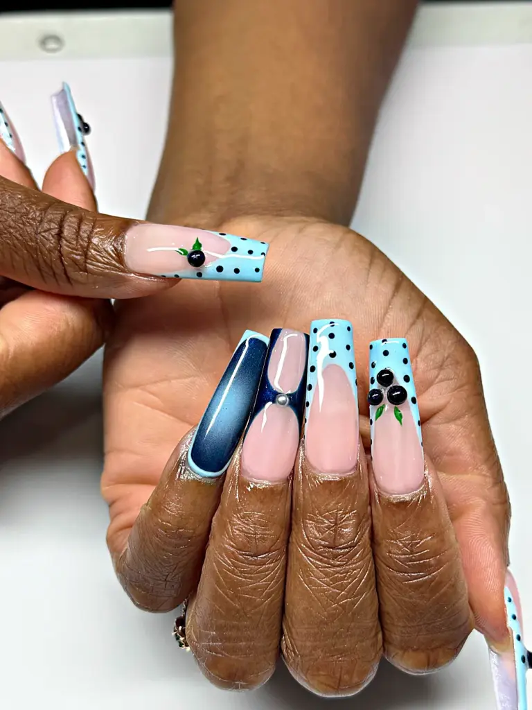 Long square Gel X nails with baby blue polka dot French tips, navy cat eye and 3D blueberries at NAB Nail Bar in Las Vegas