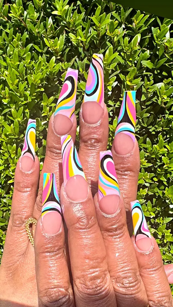 Long square Gel X nails with a retro pink, yellow and blue swirl French tip at NAB Nail Bar in Las Vegas