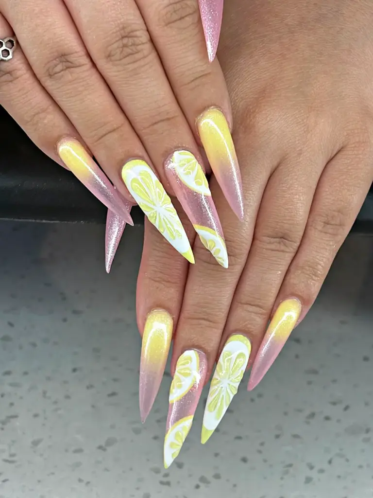 Long stiletto Gel X nails with pink and yellow shimmer ombré and hand-painted 3D lemons at NAB Nail Bar in Las Vegas