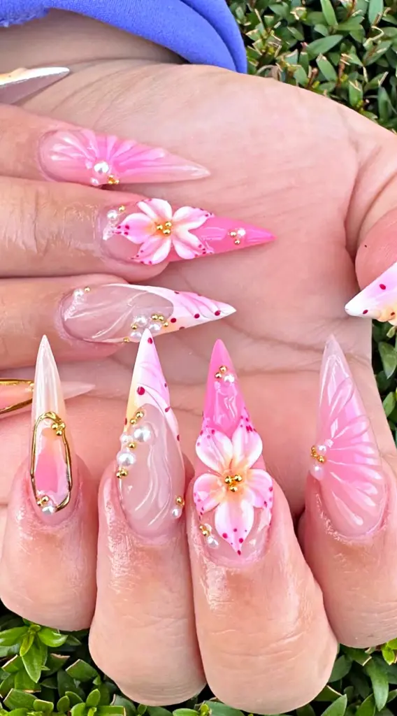 Long stiletto Gel X nails in pink with 3D flowers, pearls and gold beads at NAB Nail Bar in Las Vegas