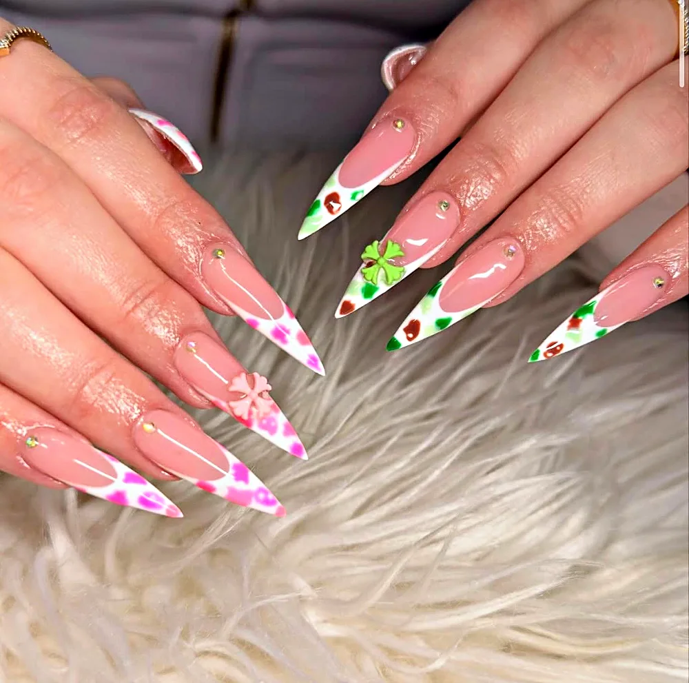 Long stiletto Gel X nails with pink and green print French tips and 3D charms at NAB Nail Bar in Las Vegas