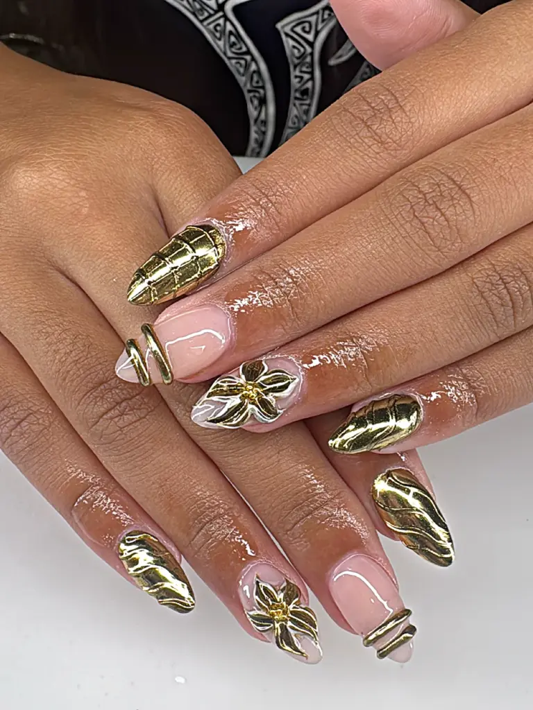 Medium almond Gel X nails with gold chrome 3D flowers and wraps at NAB Nail Bar in Las Vegas