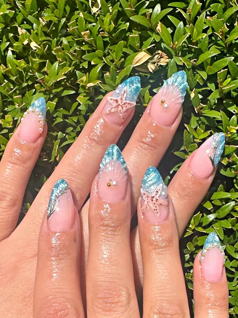 Medium almond Gel X nails with ocean blue shimmer tips, starfish and pearls at NAB Nail Bar in Las Vegas
