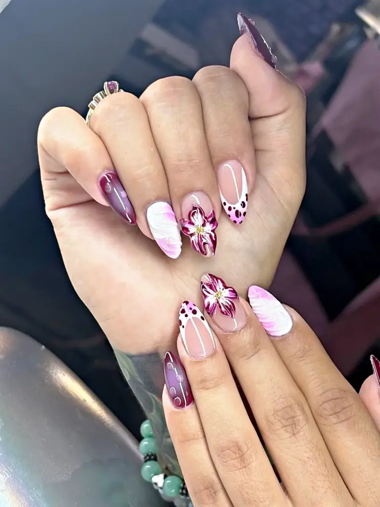 Medium almond Gel X nails with a hand-painted purple lily, aura and polka dot French at NAB Nail Bar in Las Vegas