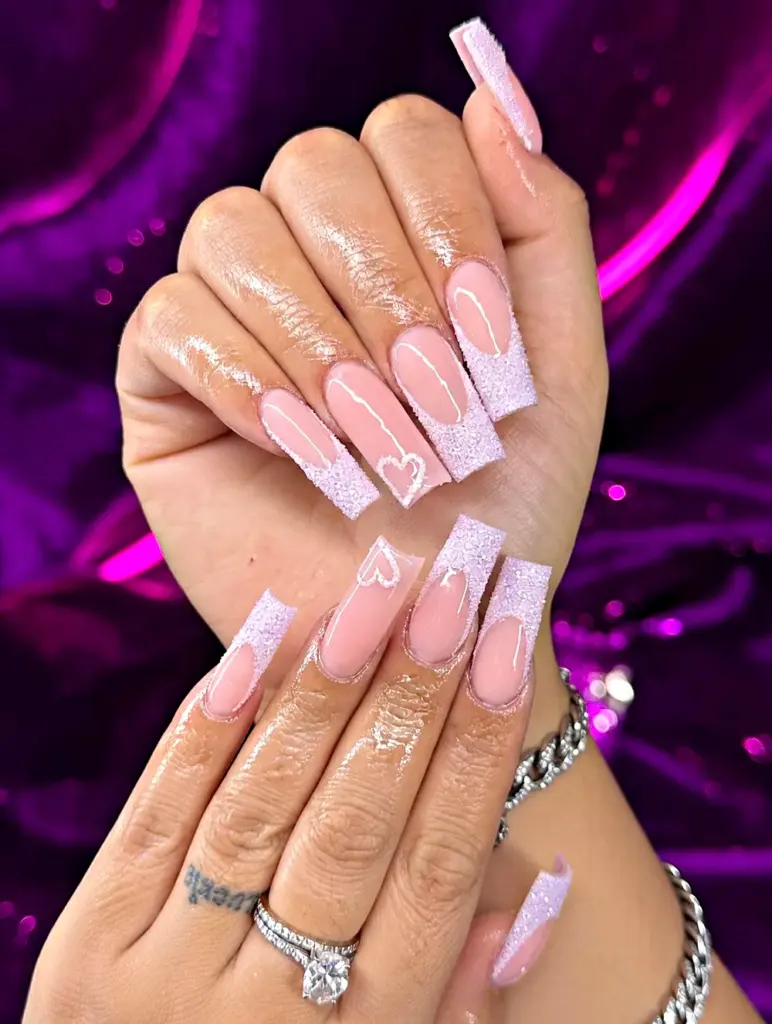 Medium square Gel X nails with a lilac sugar glitter French tip and a heart at NAB Nail Bar in Las Vegas