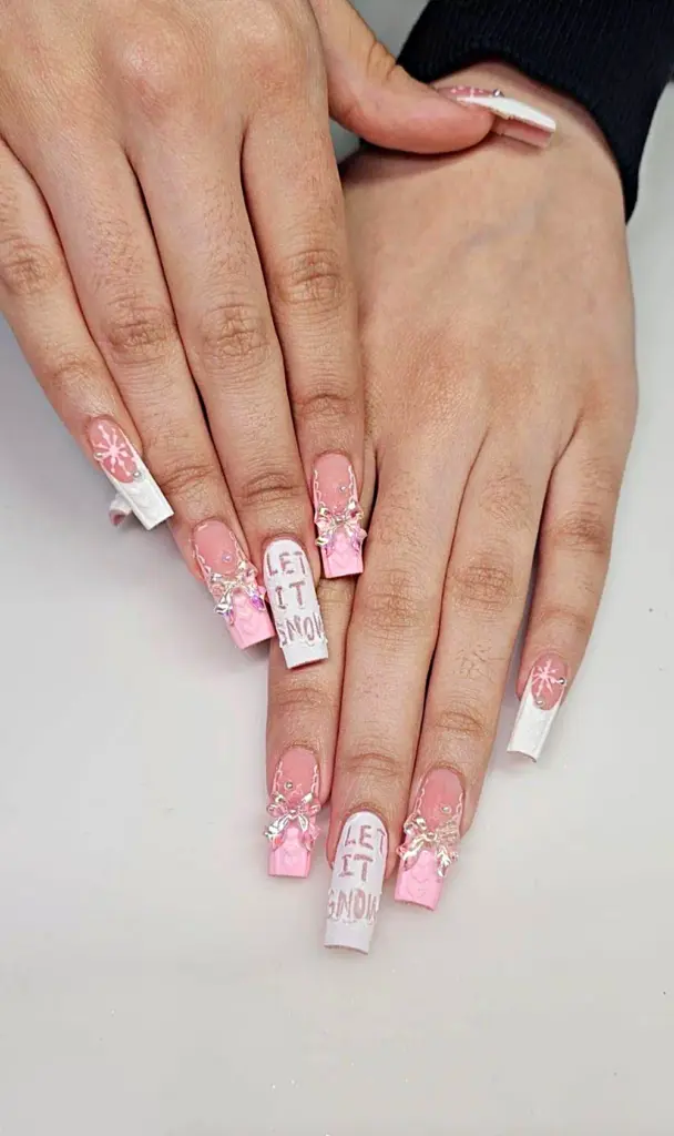 Medium square Gel X nails in pink and white with snowflakes, 3D bows and Let It Snow lettering at NAB Nail Bar in Las Vegas