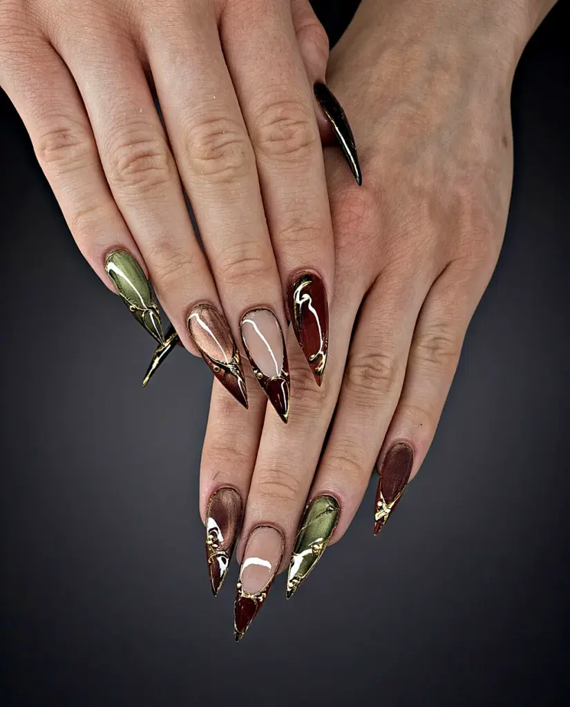 Medium stiletto Gel X nails in olive and burgundy cat eye with gold chrome lines at NAB Nail Bar in Las Vegas