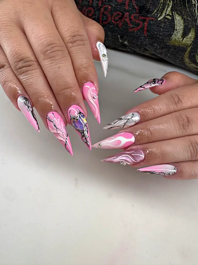 Medium stiletto Gel X nails in pink with silver chrome lines and an opal heart at NAB Nail Bar in Las Vegas