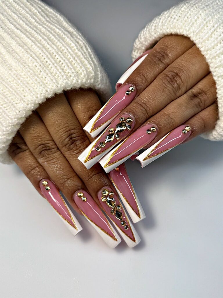 Pink and white French holiday coffin nails with gold lines and gold studs at NAB Nail Bar, Las Vegas
