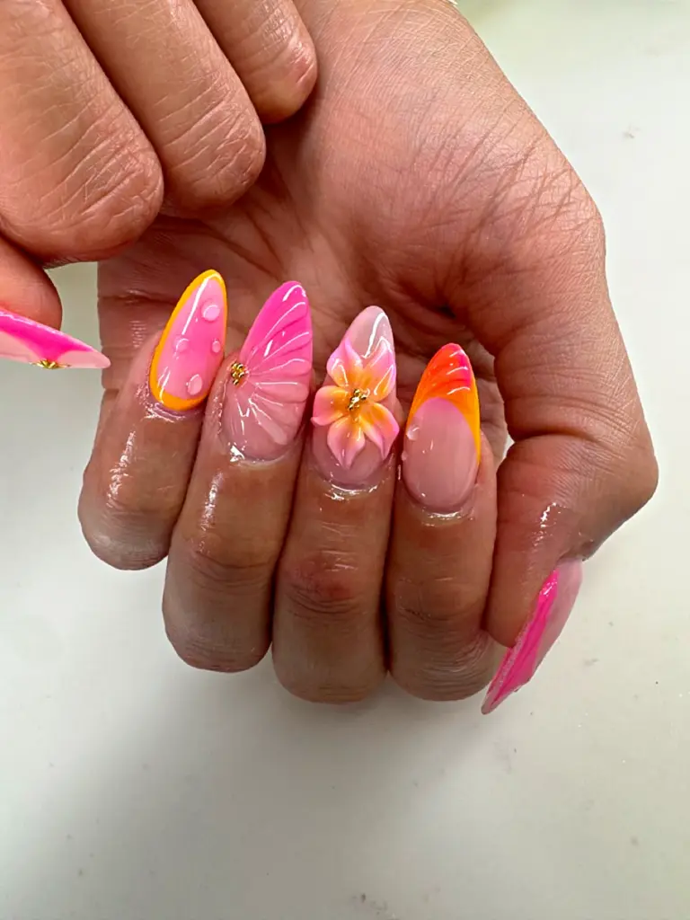 Short almond Gel X nails in pink and orange with a butterfly wing and 3D flower at NAB Nail Bar in Las Vegas