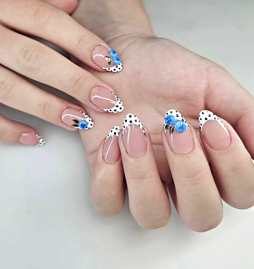 Short almond Gel X nails with a polka dot French tip and 3D blueberries at NAB Nail Bar in Las Vegas