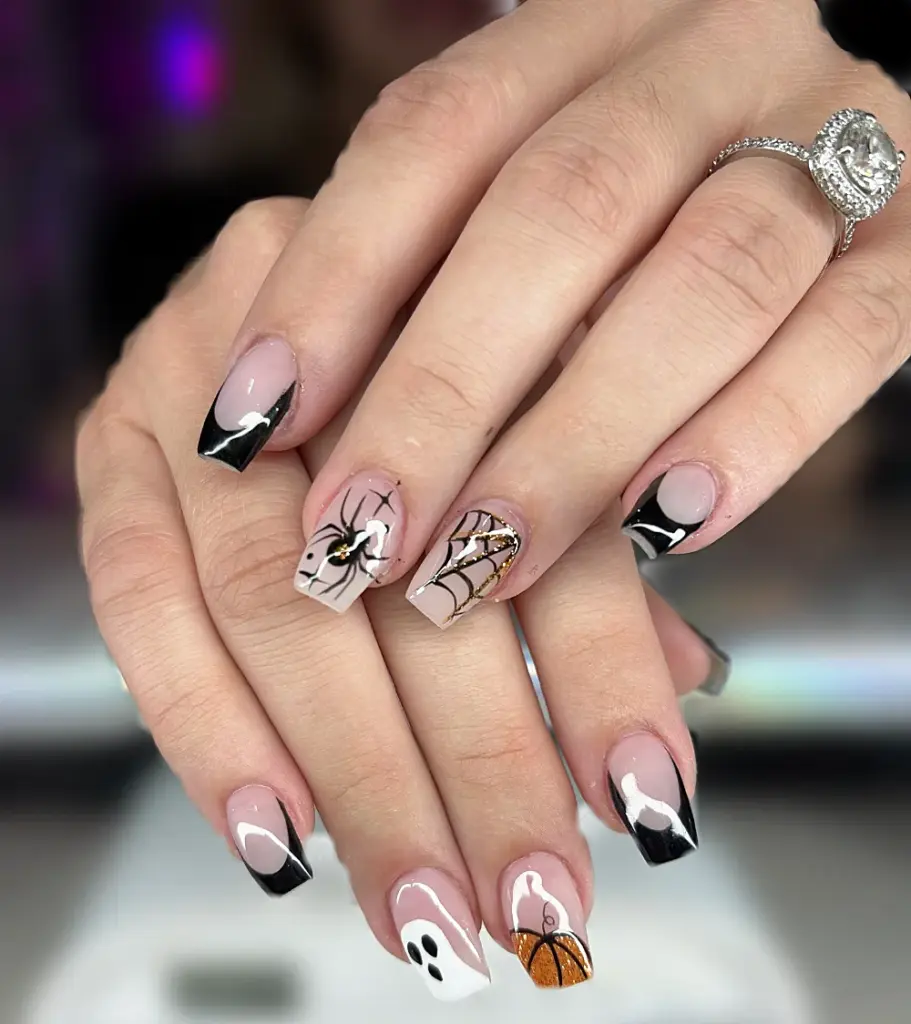 Short coffin Gel X nails with black French tips, a spider, web, ghost and glitter pumpkin at NAB Nail Bar in Las Vegas