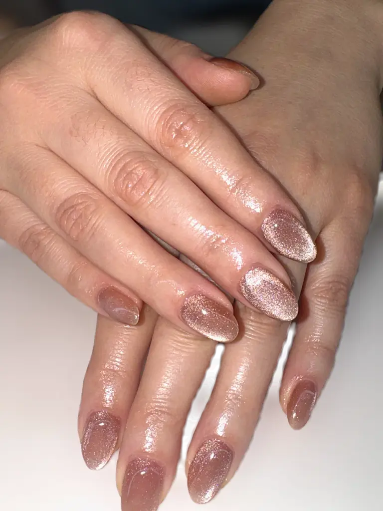 Medium oval Gel X nails in rose gold cat eye shimmer at NAB Nail Bar in Las Vegas